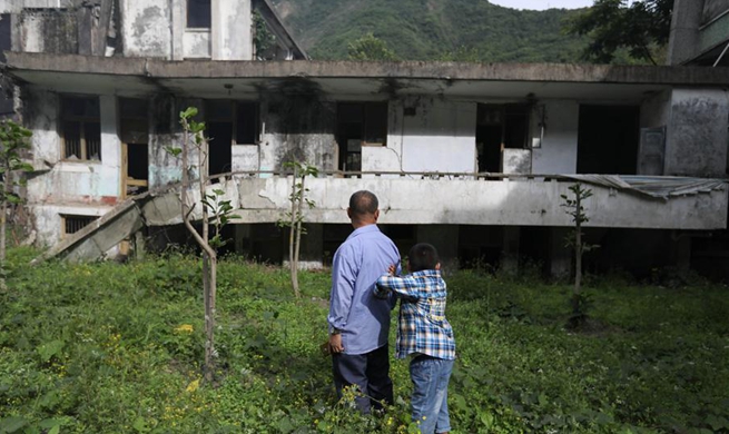 People visit earthquake-destroyed old-town area of Beichuan, SW China